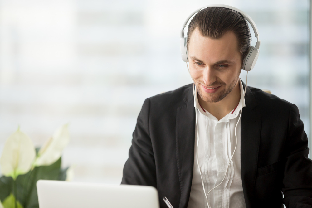 Professional working with headphones and laptop
